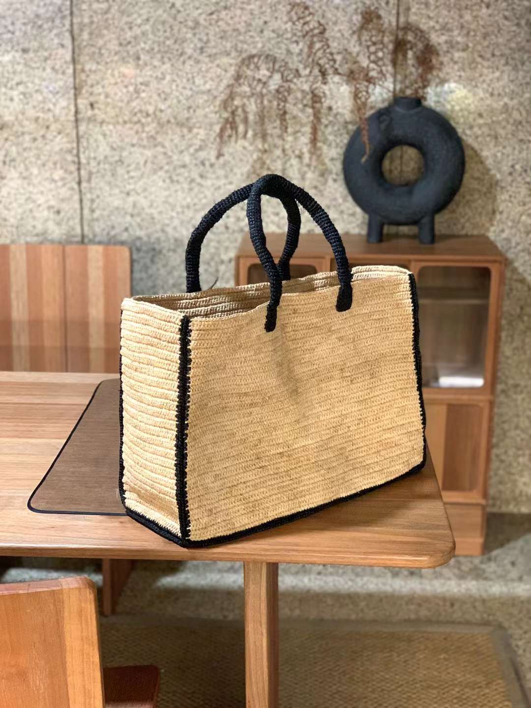 crochet straw tote in rectangle shape, with wide opening and black color handles