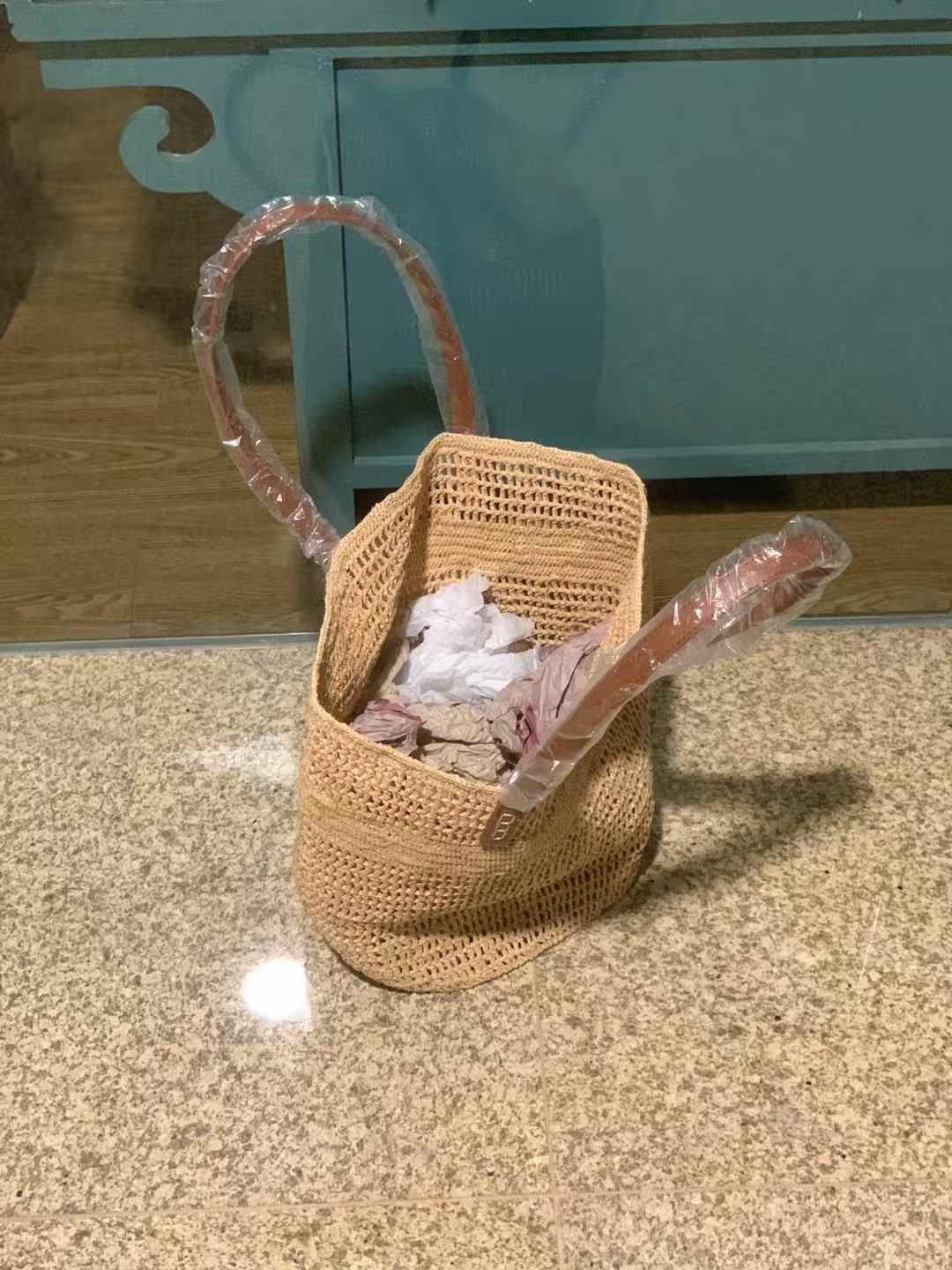 Wide opening crochet raffia bag with leather shoulder straps, natural color in crochet hollow pattern