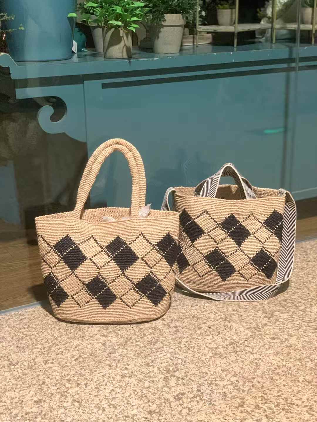 two straw bag features a classic tote shape, black diamond pattern, one with two sturdy straw top handles, the other one is with cotton strip hand carry handle and a long strap for crossbody wear.