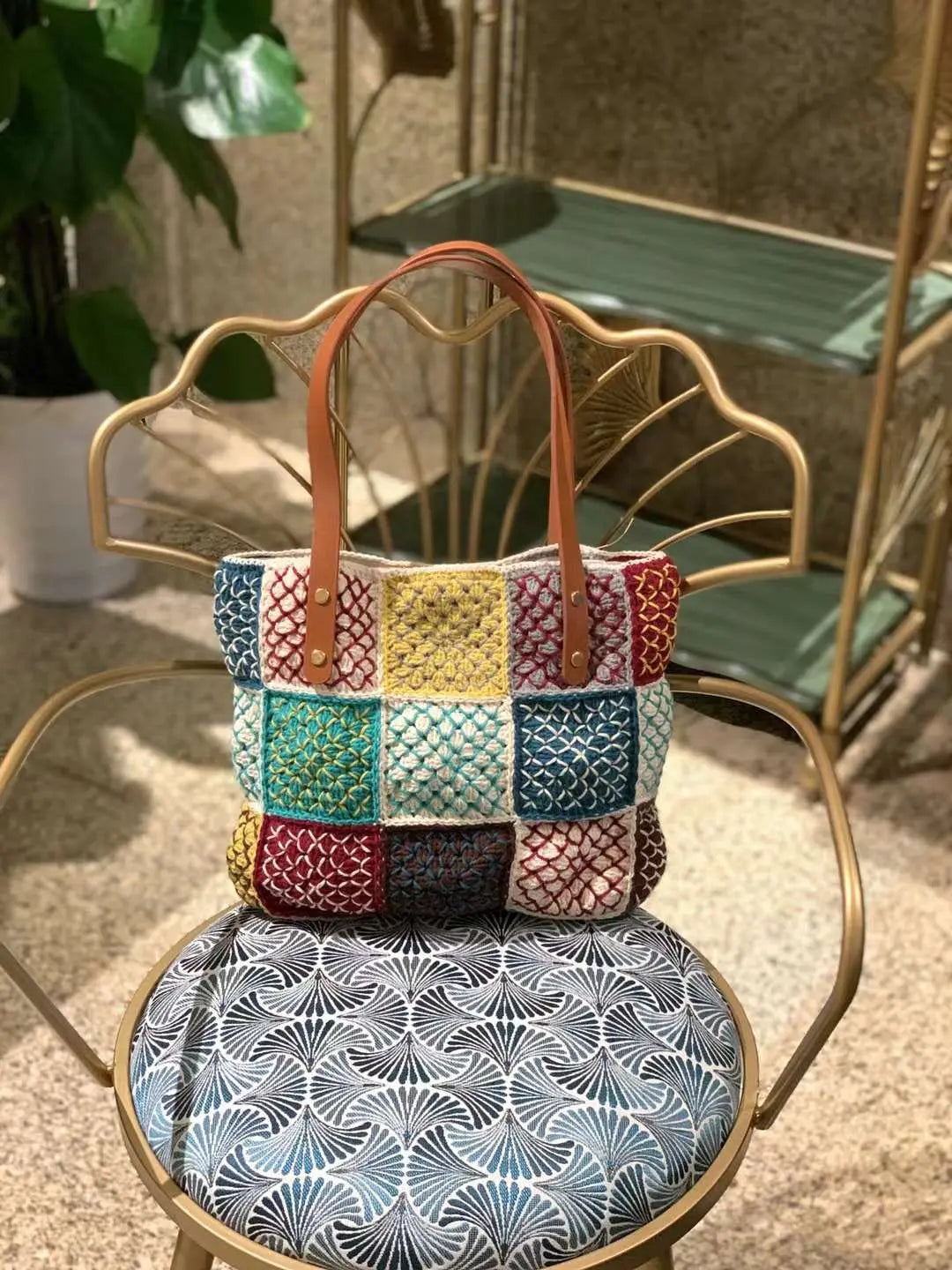 crochet tote with hand embroidery feature cotton lining and genuine leather shoulder straps."