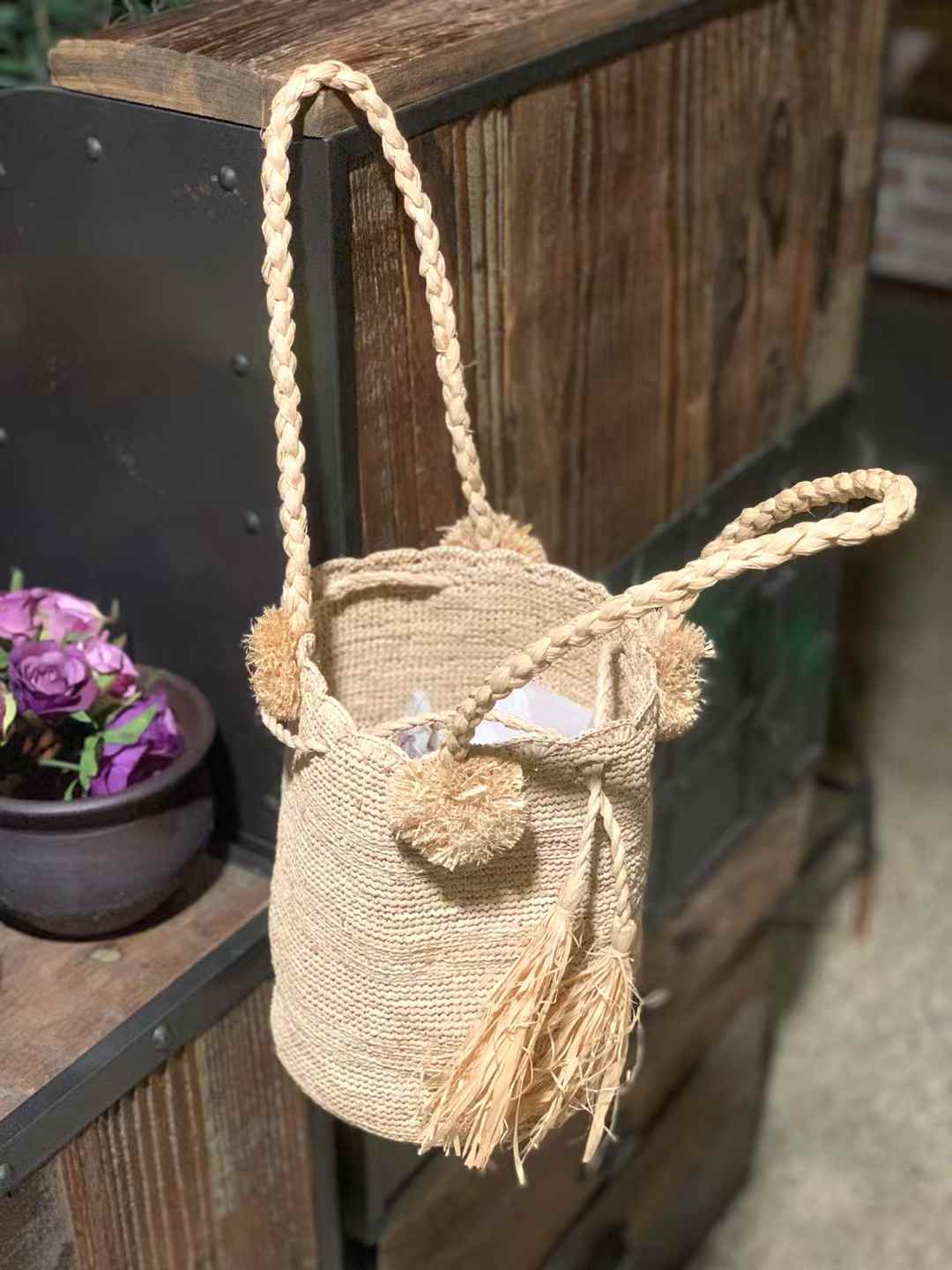 crochet bucket bag with 2 handles in raffia straw, drawstring and pompom decor