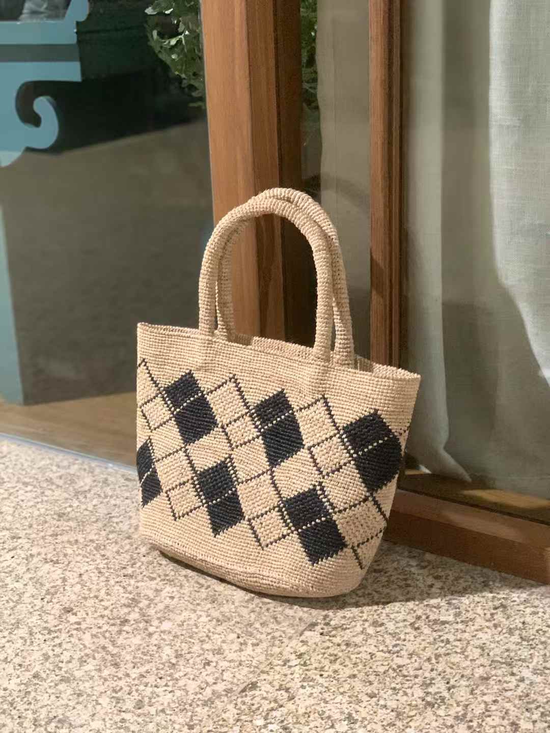 handmade straw beach bag features a classic tote shape with two sturdy straw top handles