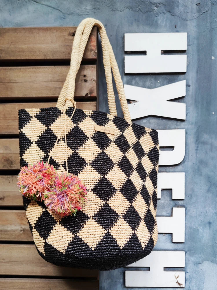 straw beach bag with pom pom bag charm