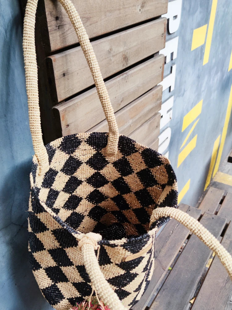 straw beach bag with pom pom bag charm