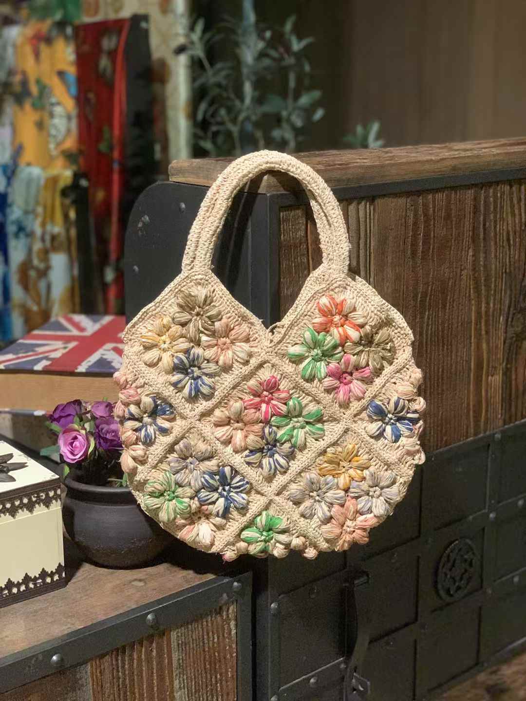 Handmade flower straw bag with colorful crochet flower design, featuring natural tones and top handles — perfect for summer beach or casual wear